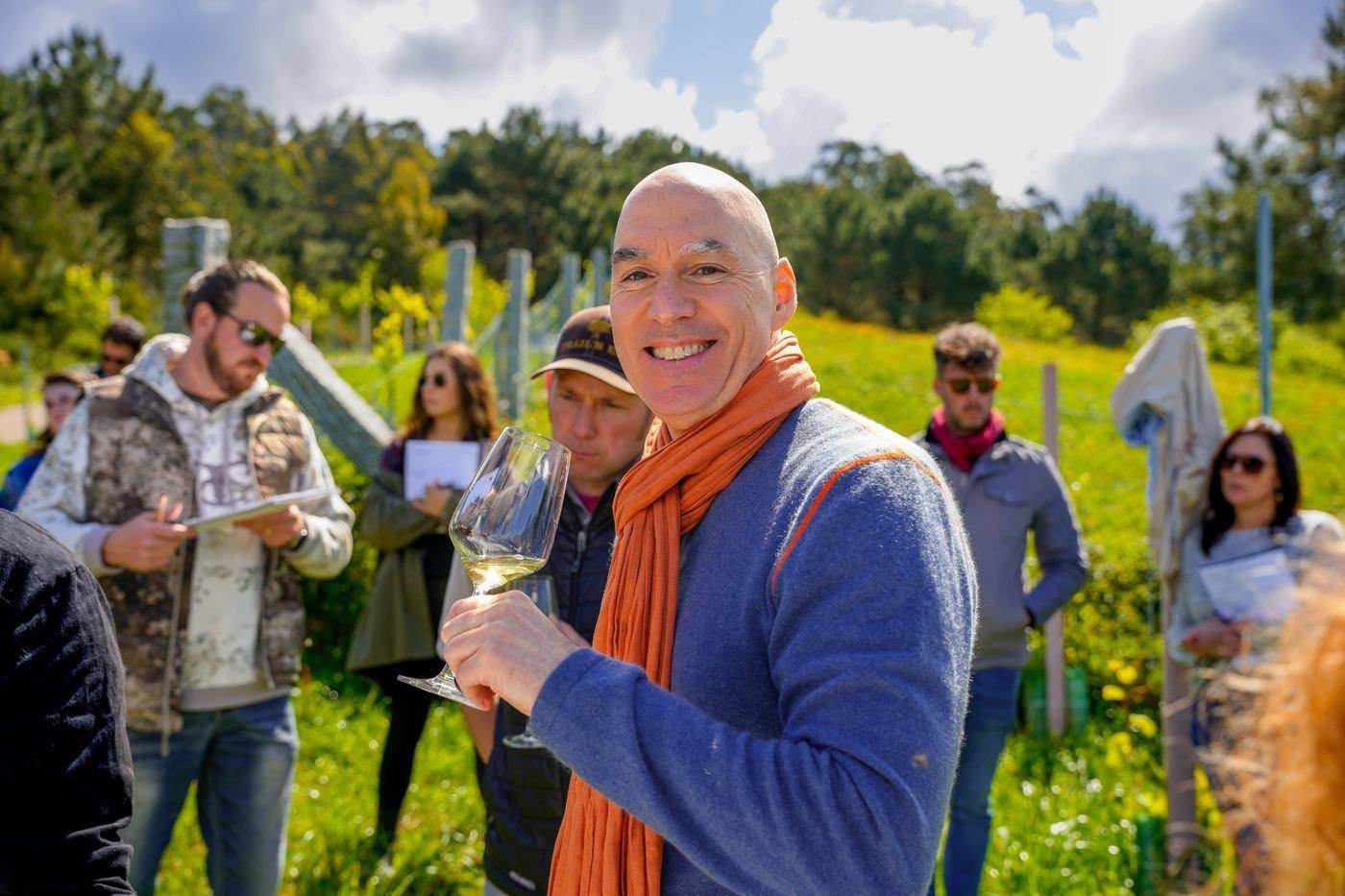 Tasting white wine in a hillside vineyard